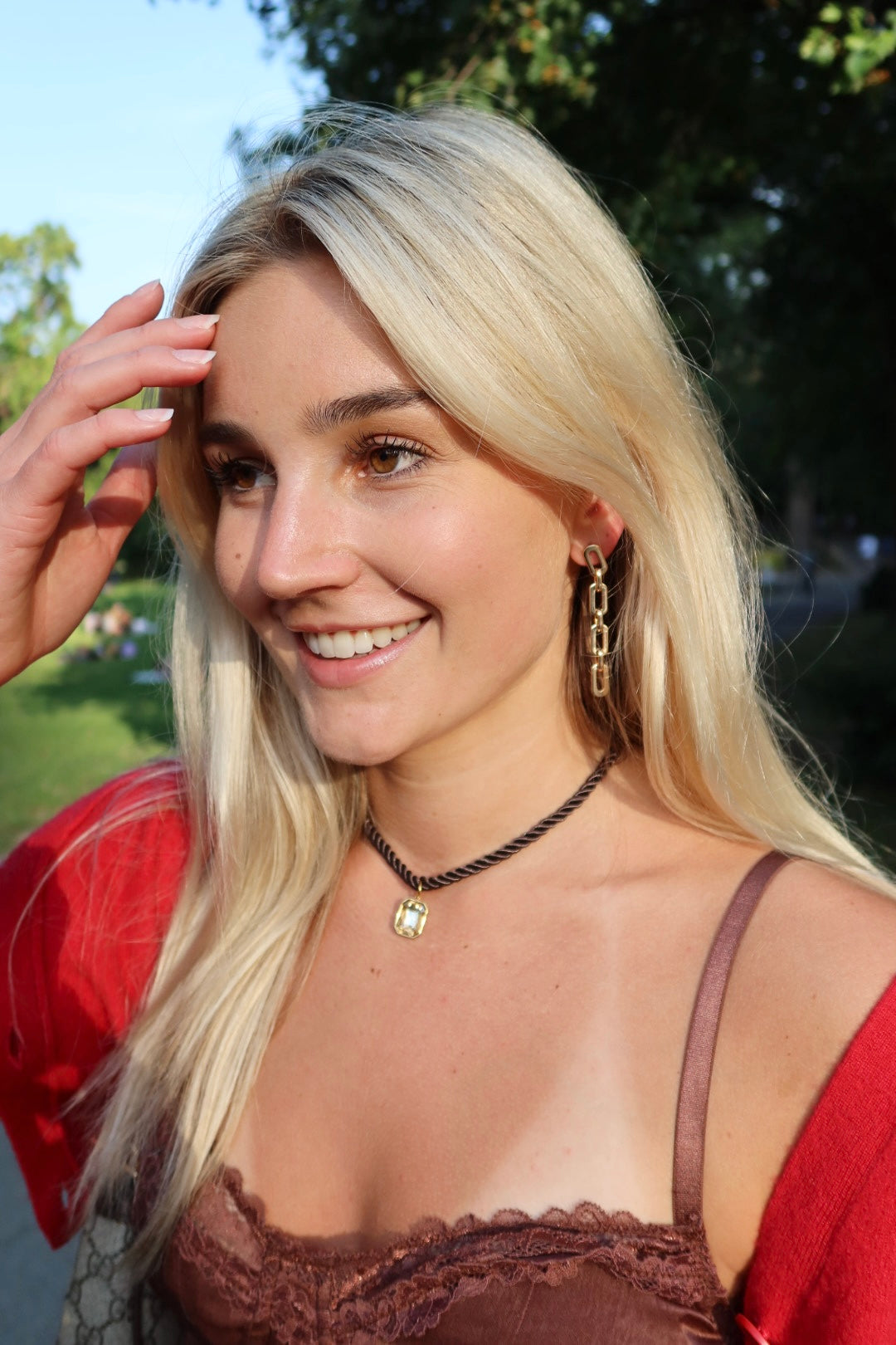 Woman with blonde hair and a red top outdoors