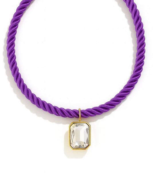 Purple braided hair tie with a clear crystal pendant on a white background