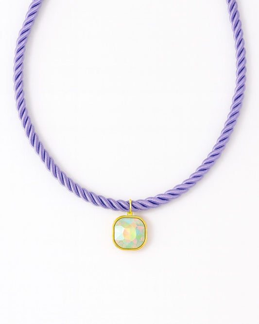 Necklace with a purple cord and a square pendant on a white background