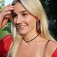 Woman with blonde hair and a red top outdoors