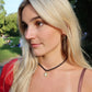 Woman with blonde hair and a red top in an outdoor setting linny co