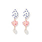 Pair of earrings with white teardrop-shaped beads, pink polka dot beads, and gold accents on a white background.