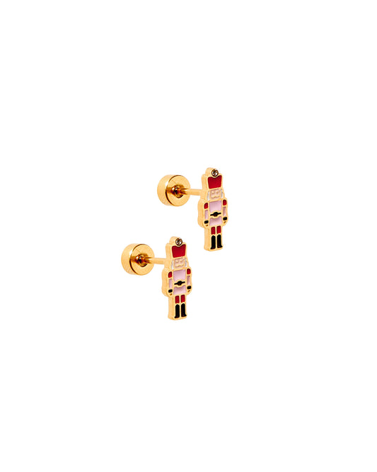 Gold nutcracker-shaped earrings on a white background